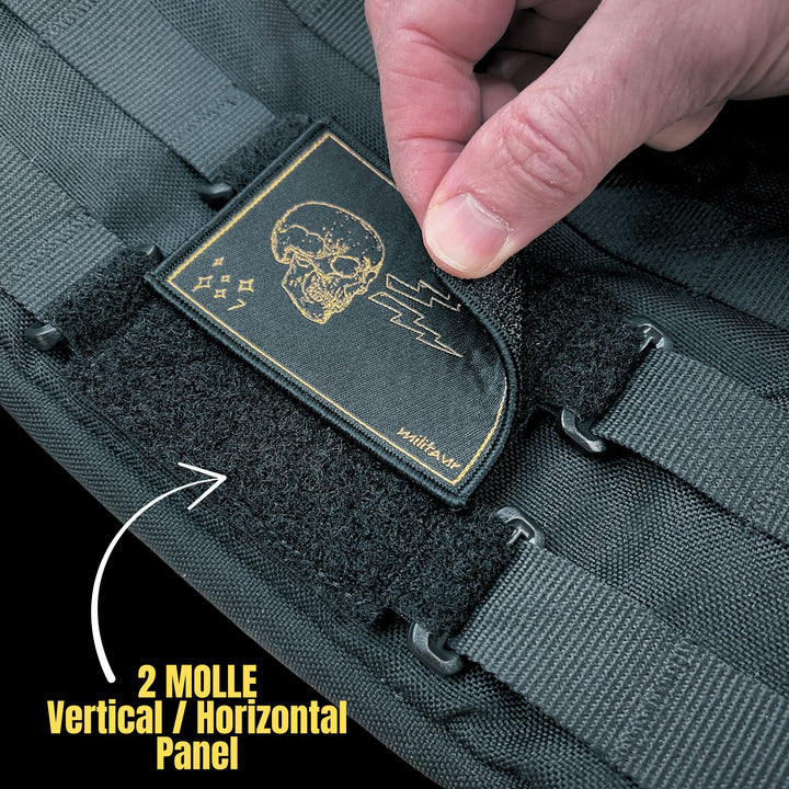 Close-up of a skull-themed Miltuar patch being applied to a tactical bag with 2 MOLLE vertical/horizontal of the Militaur panel set in black.