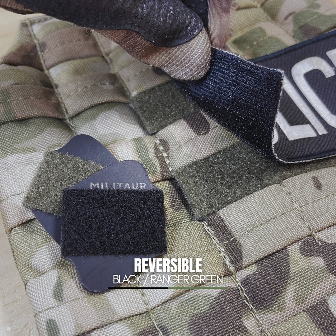 Camouflage fabric with reversible black and ranger green militaur loop discs on a military-style background.