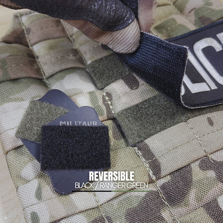 Camouflage fabric with reversible black and ranger green militaur loop discs on a military-style background.